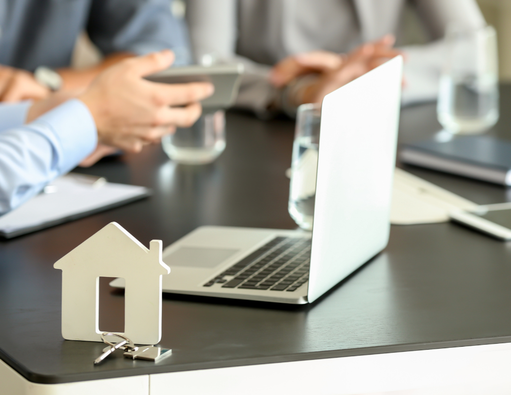 table with computer and wood house