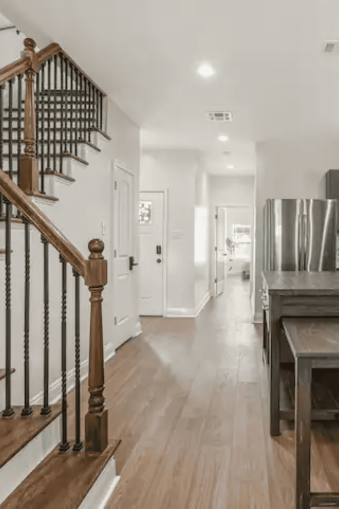 room with stairs and table white hallway