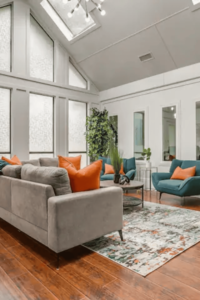 couch in open living room with vaulted ceiling